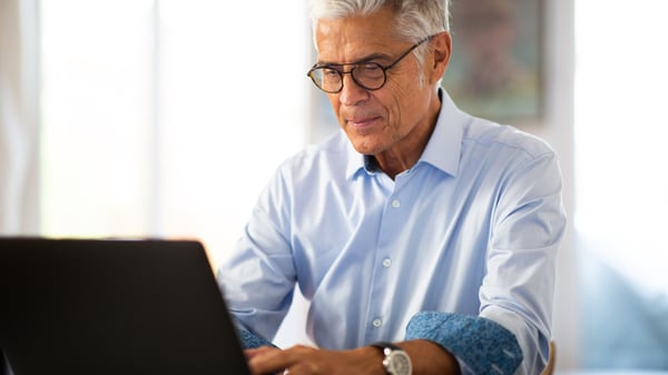 Man typing on his laptop 
