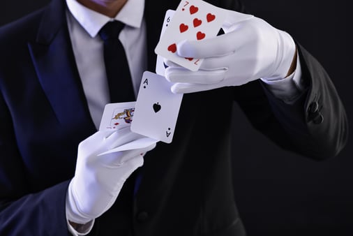 The concept of sales magic. A magician doing a card trick. 