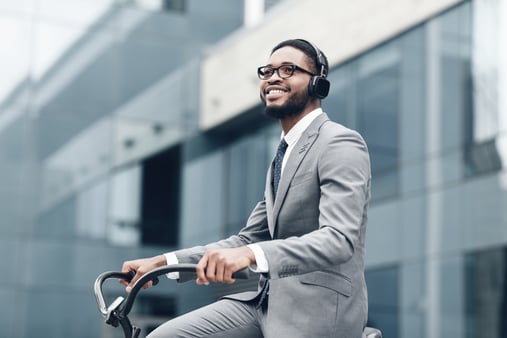 The concept of continuous learning. A man listening to a podcast on his commute to work. 