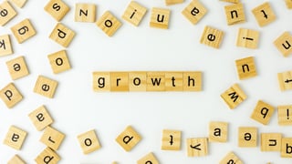 Scrabble letters that spell out the word growth 