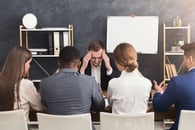 A businessperson who is having a bad meeting with clients. 