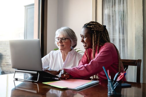 A younger businessperson learning from an older businessperson