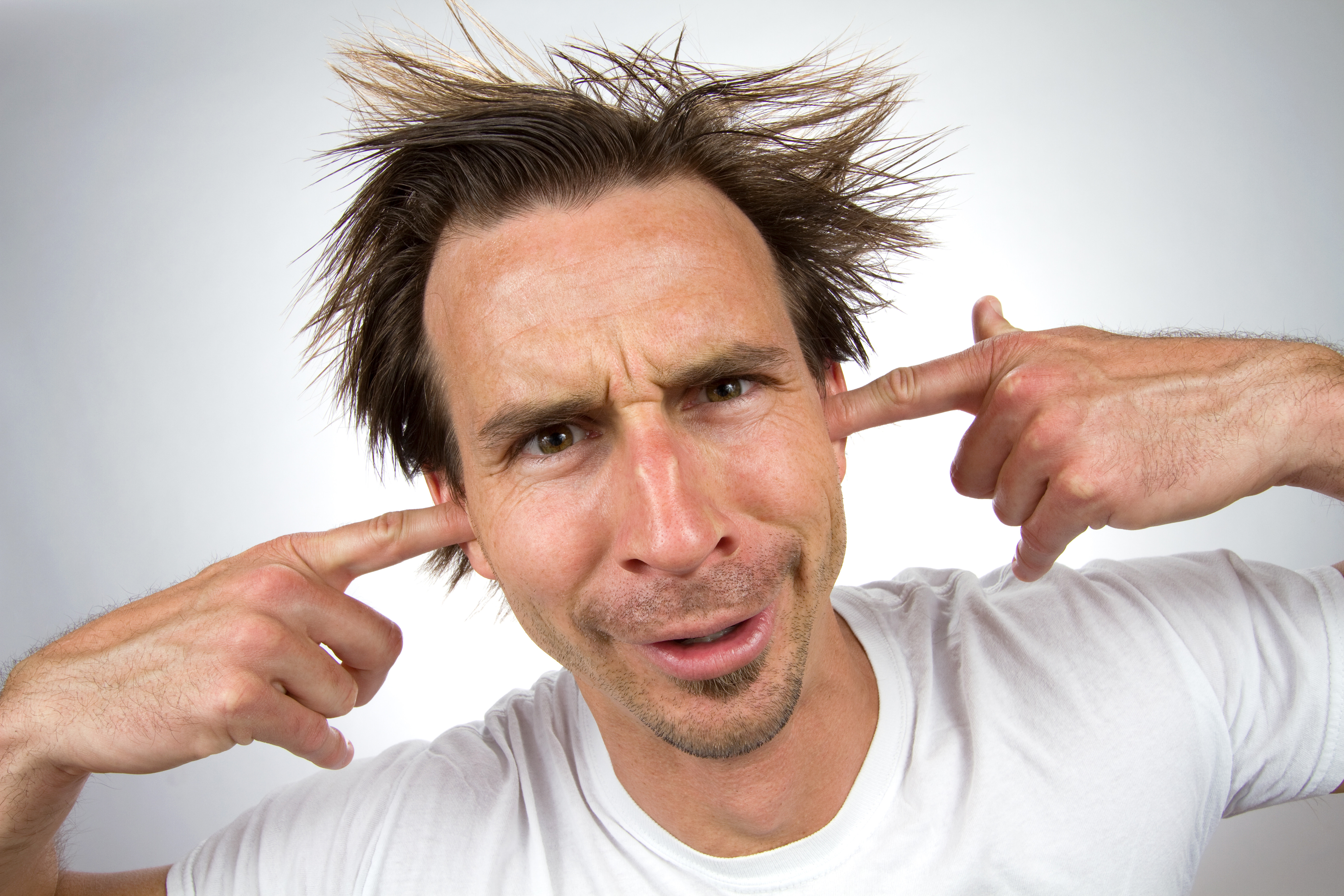 Man plugging his ears