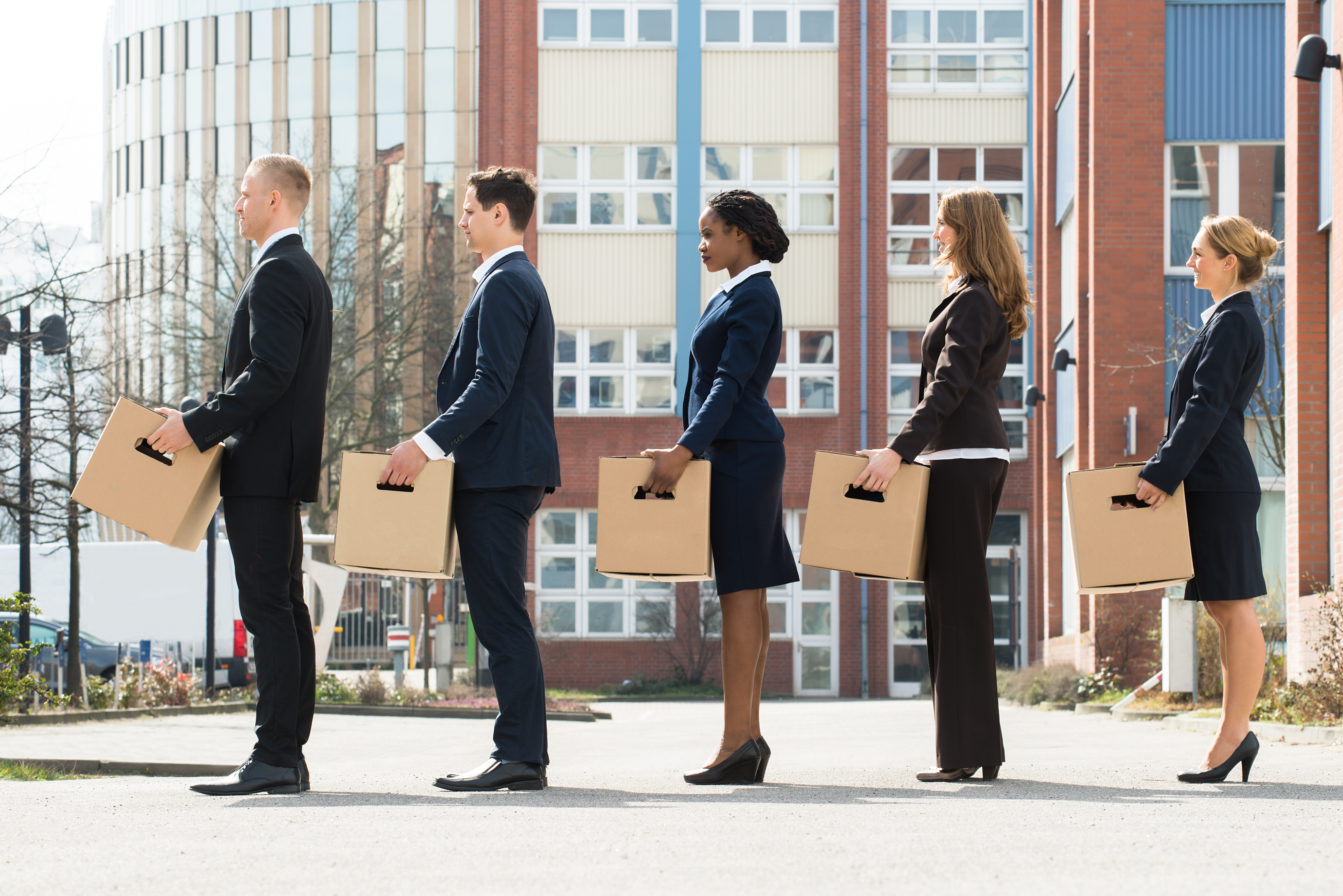 Business people leaving with boxes
