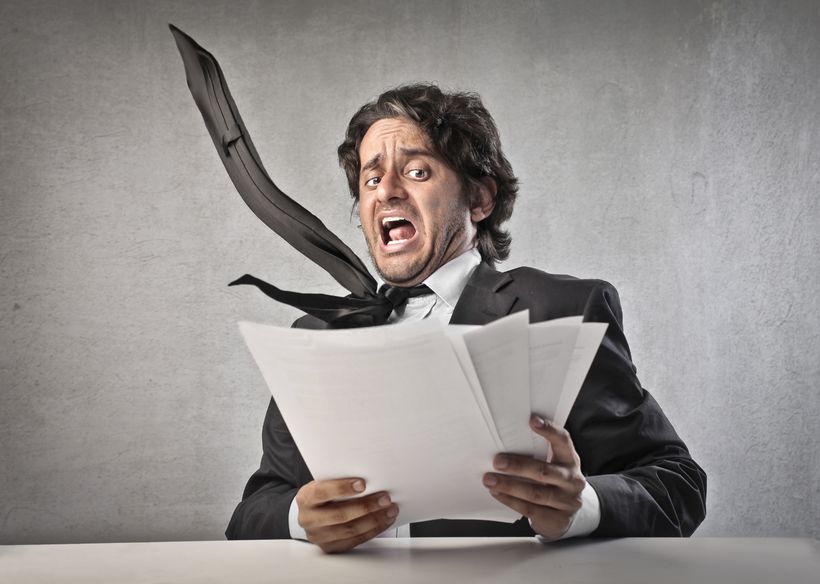 Man looking at a stack of papers