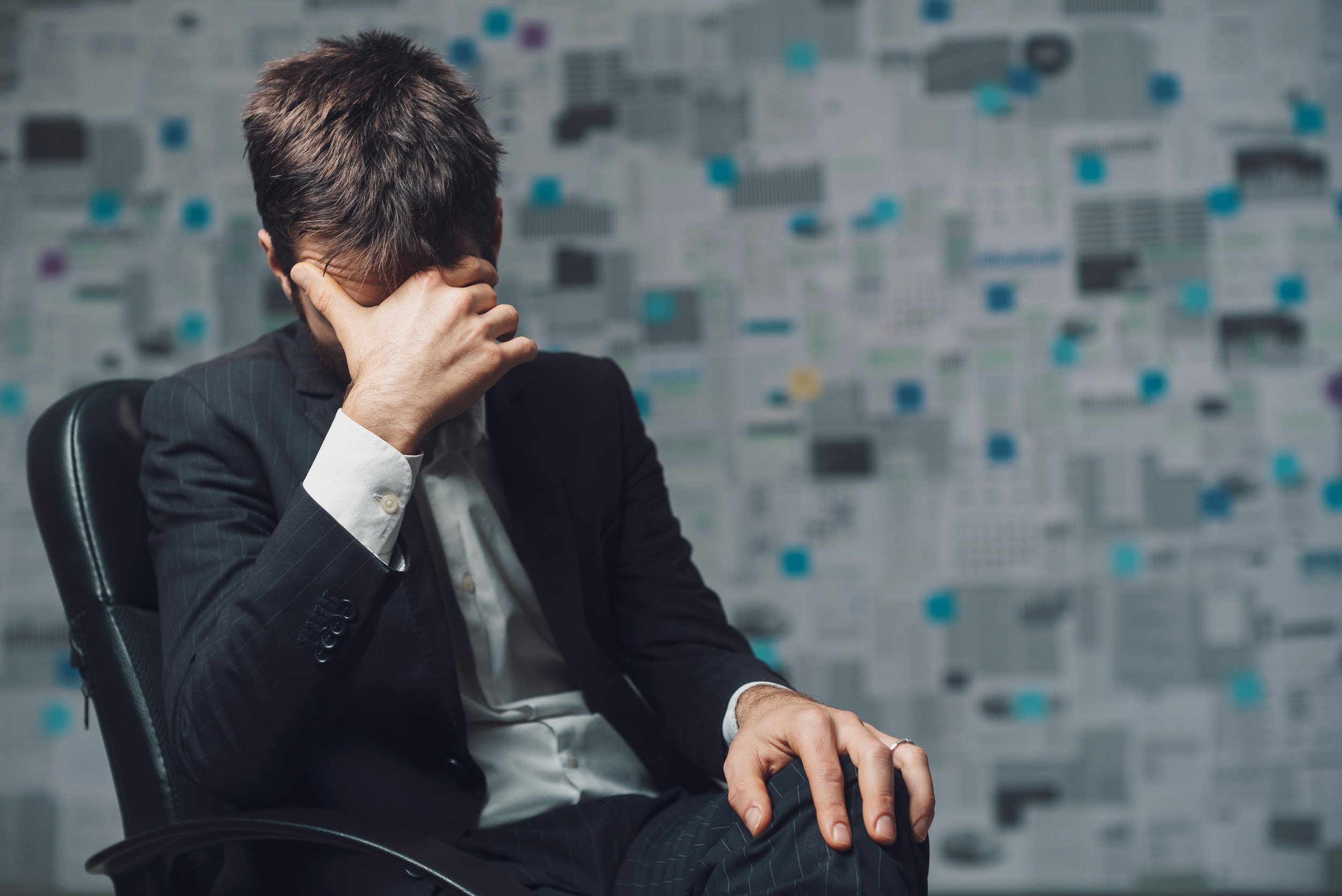 A worried salesperson with his head in his hand, representing repressed emotions