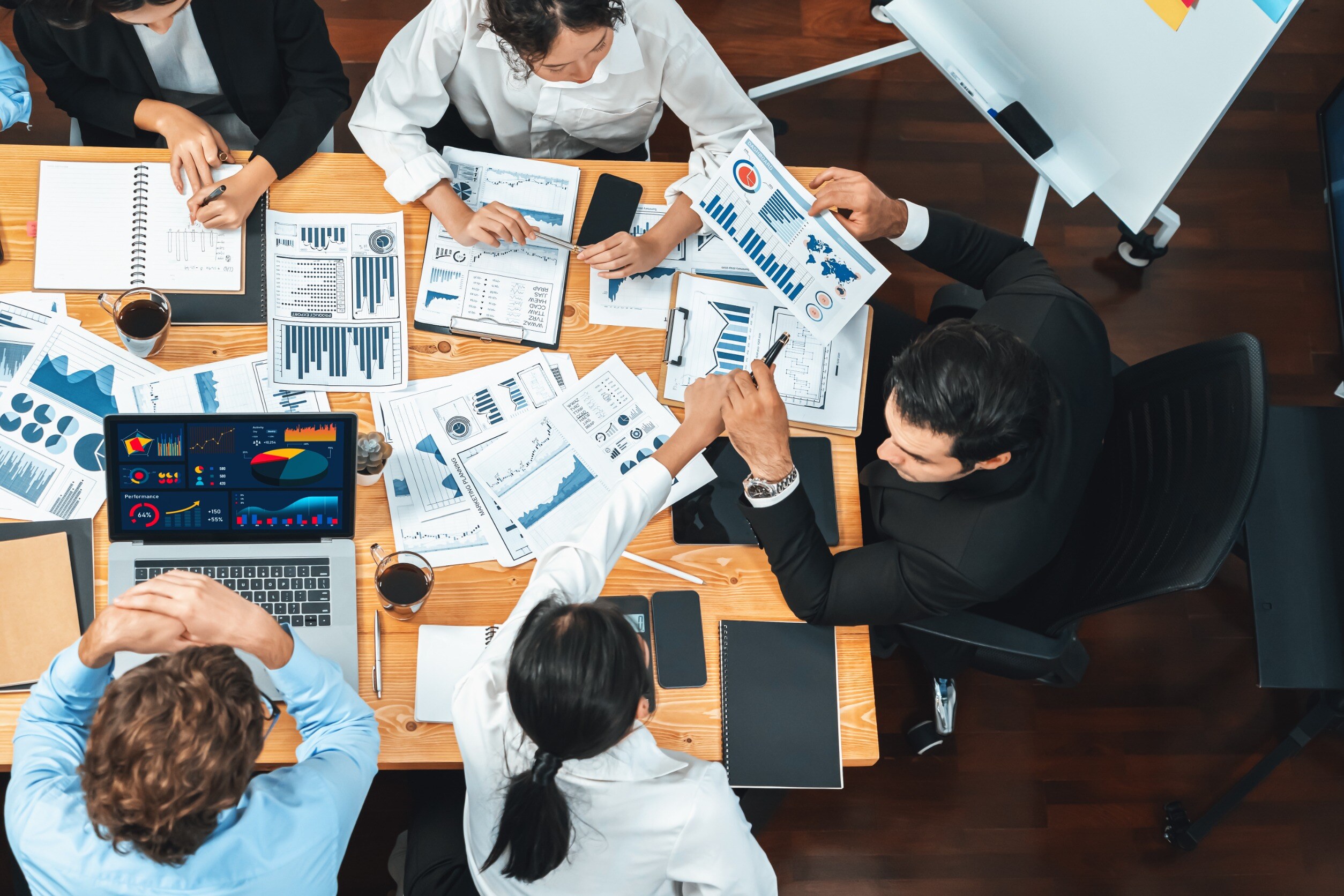 Concept of structured processes. A business team looking at blueprints and charts. 