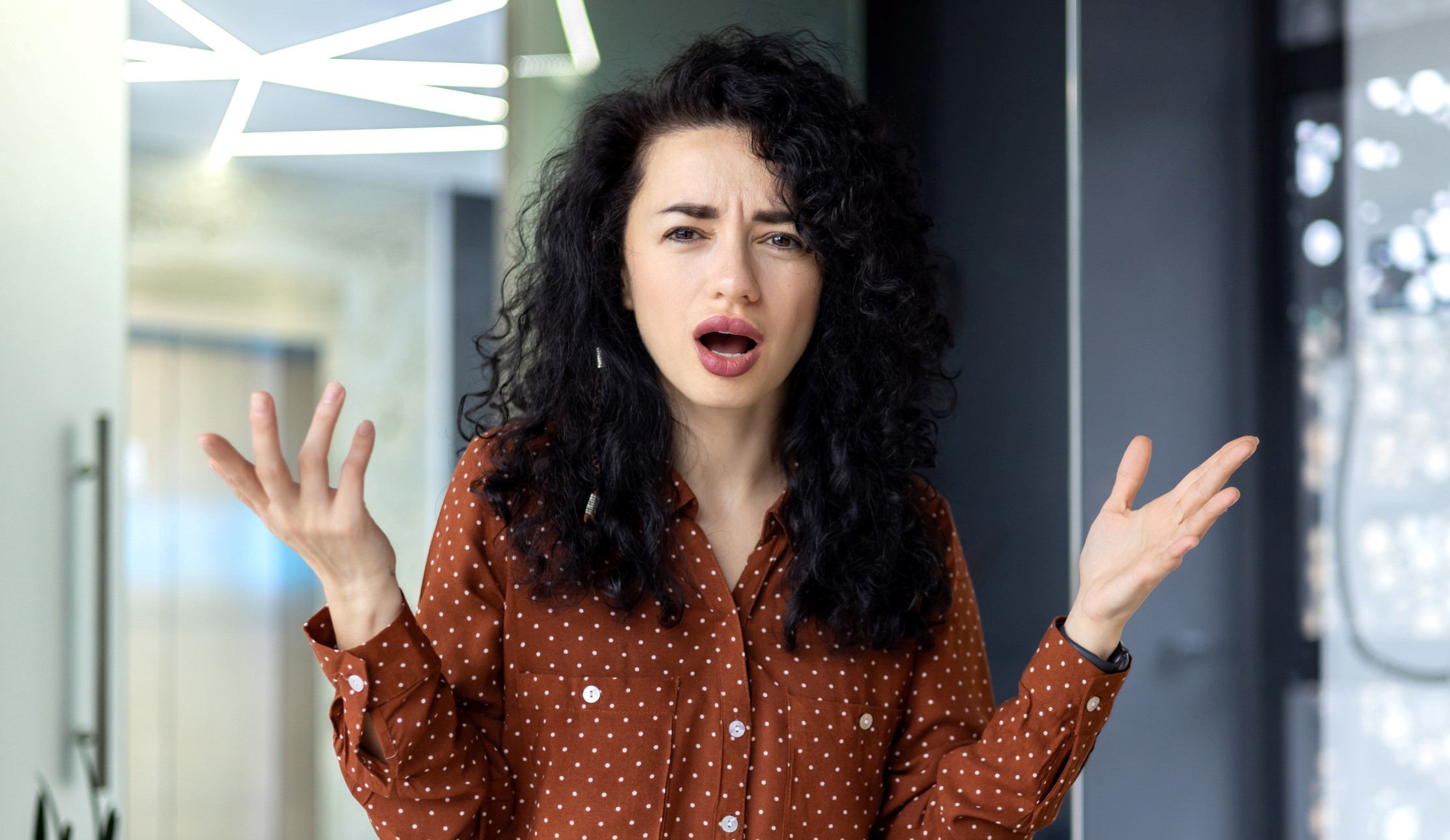 Woman with her hands thrown in the air in frustration